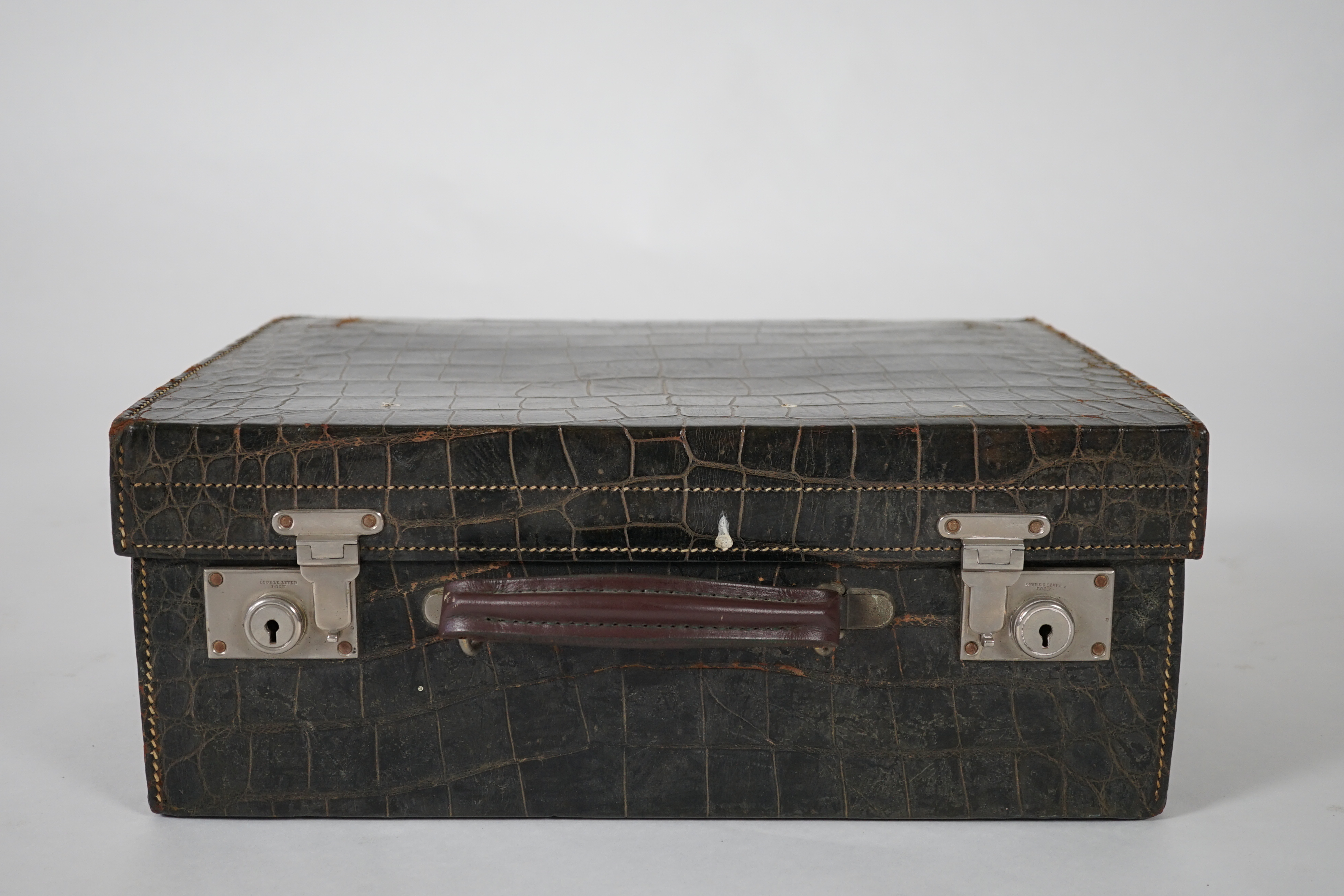 A George V green crocodile toilet case, 46cm x 33cm x 18cm